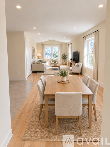 A dining room with a wooden table and chairs.