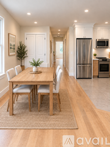 A dining room with a wooden table and chairs.