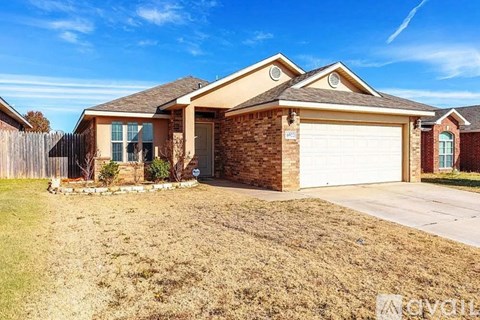 A house with a brown brick exterior and a white garage door.
