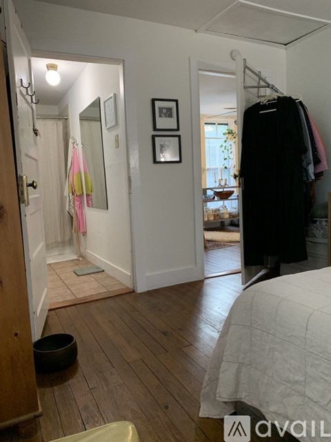A bedroom with a bed, a wardrobe, and a mirror.