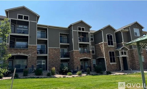 A row of modern apartment buildings with balconies and doors.