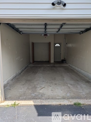 A white garage door with a small window in the middle.