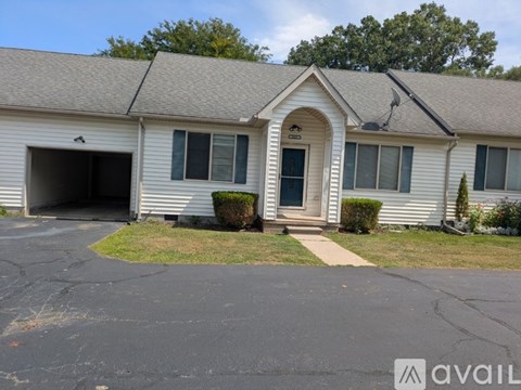 A house with a garage and a driveway in front.