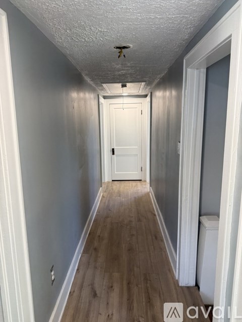 A long hallway with a door at the end.