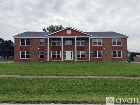 A red brick building with a white door in the center.