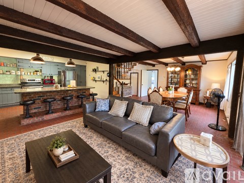 A living room with a grey couch and a coffee table.
