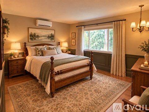 A bedroom with a large bed and a window with curtains.