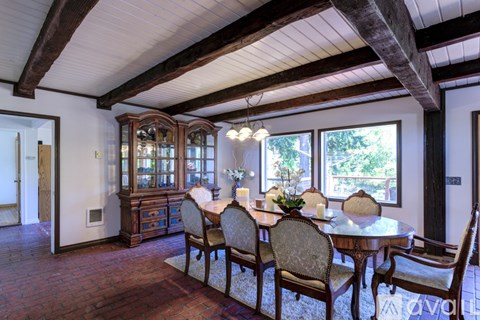 A dining room with a table set for six.