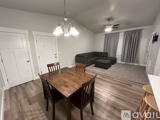 A dining room with a wooden table and chairs.