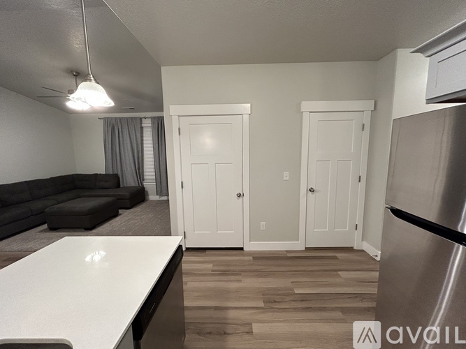 A kitchen with a refrigerator on the right side.