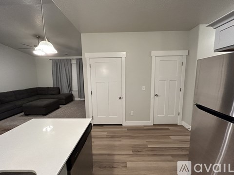 A kitchen with a refrigerator on the right side.