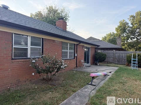 A house with a brick exterior and a small front yard.