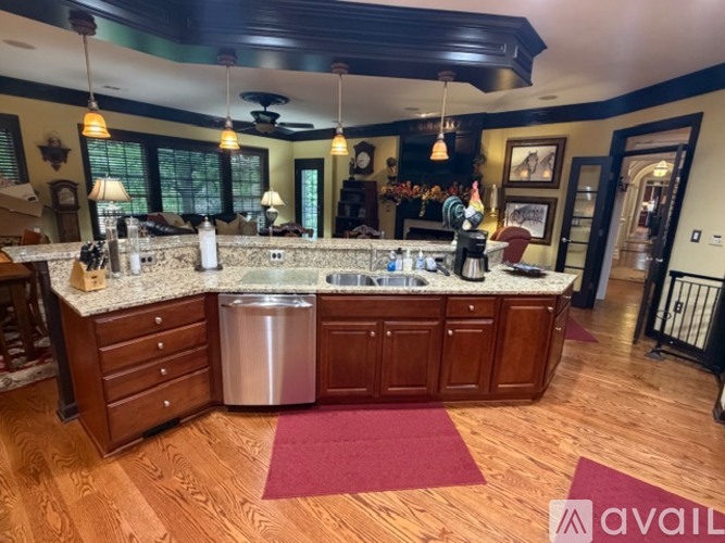 A kitchen with wooden cabinets and a marble countertop.