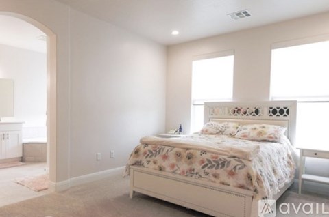 A bedroom with a large bed and a window.