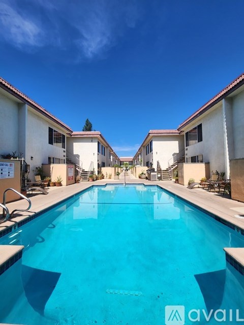 A swimming pool in front of a building with the logo "avail" on the bottom right.