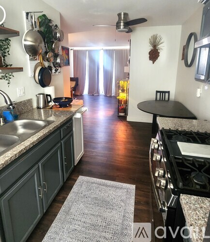 A kitchen with a stove top oven and a table.