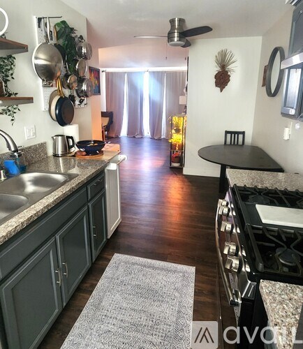 A kitchen with a stove top oven and a table.