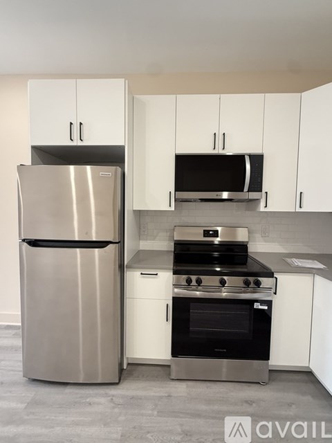 A kitchen with a stainless steel refrigerator and oven.