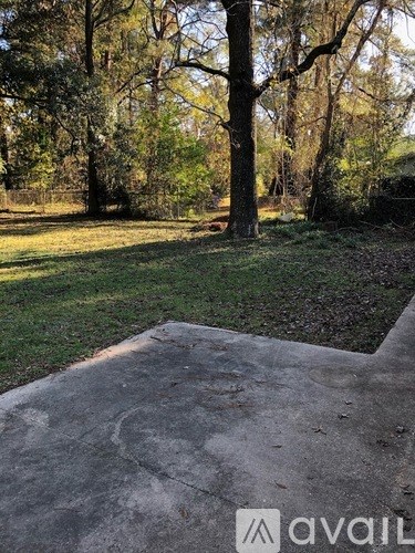 A concrete area surrounded by trees.