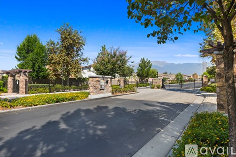A street view of a residential area with houses and trees.