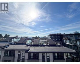 A sunny day in a city with buildings and a clear blue sky.