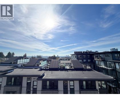 A sunny day in a city with buildings and a clear blue sky.