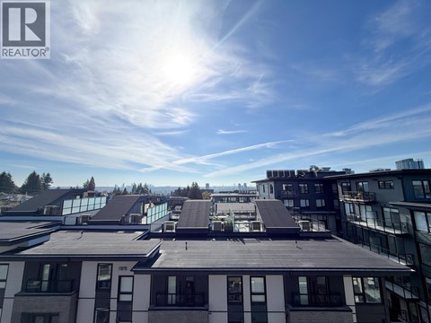 A sunny day in a city with buildings and a clear blue sky.