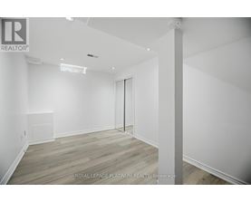 A white room with a door and a window.