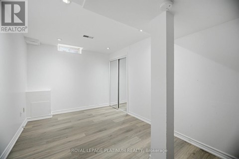 A white room with a door and a window.