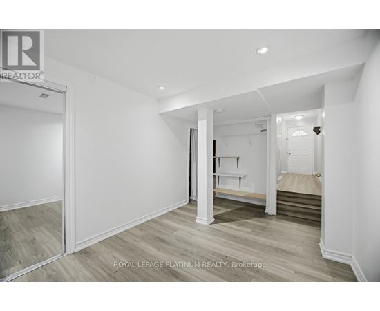 A white bedroom with a bed and a wardrobe.