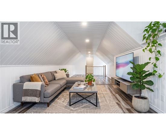 A living room with a grey sofa, a coffee table, and a television.