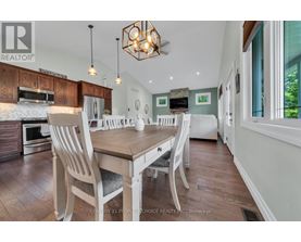A dining room with a wooden table and chairs.