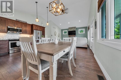 A dining room with a wooden table and chairs.