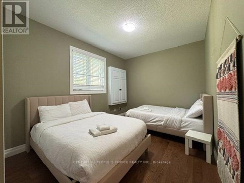 A bedroom with two beds and a window.