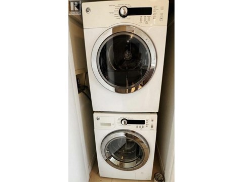 Two front loading washing machines stacked on top of each other.