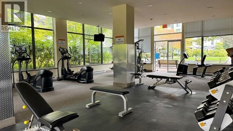 A gym with a variety of equipment including weights and cardio machines.