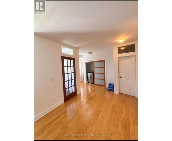 A room with wooden floors and white walls.