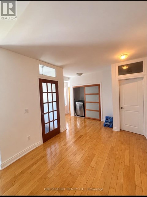 A room with wooden floors and white walls.