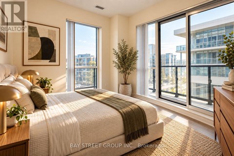 A bedroom with a large bed and a view of the city.