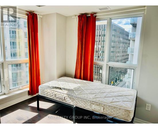 A bedroom with a large bed and red curtains.