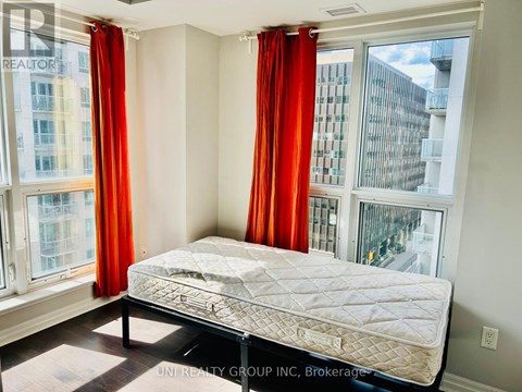 A bedroom with a large bed and red curtains.