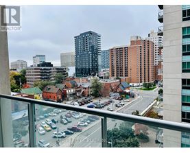 A view from a high-rise building looking down at a busy street with cars and buildings.