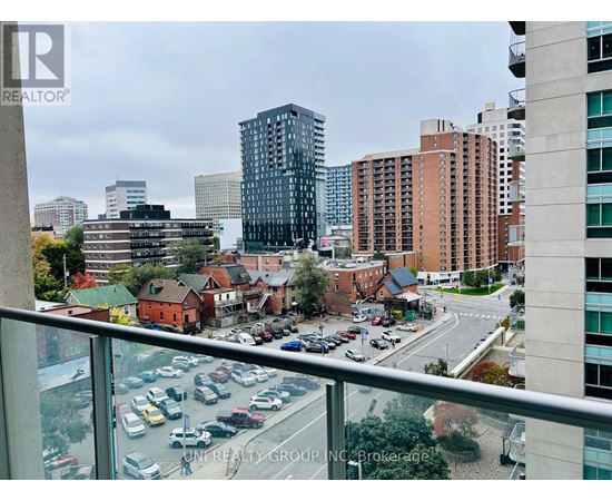 A view from a high-rise building looking down at a busy street with cars and buildings.