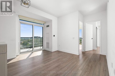 A spacious room with a view of the city through the windows.