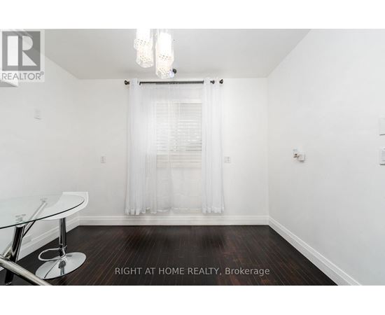 A room with a glass table and a white chair.