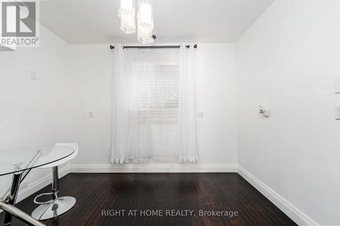 A room with a glass table and a white chair.