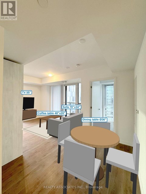 A living room with a TV, sofa, and dining table.
