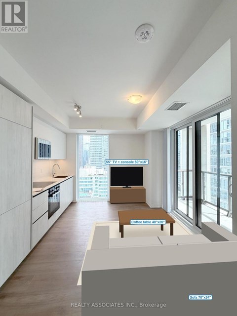 A modern kitchen with a TV and a coffee table.