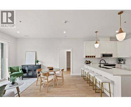 A modern kitchen with a dining table and chairs.