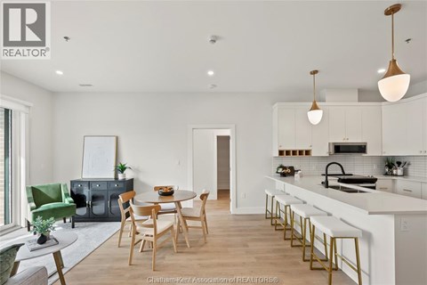 A modern kitchen with a dining table and chairs.